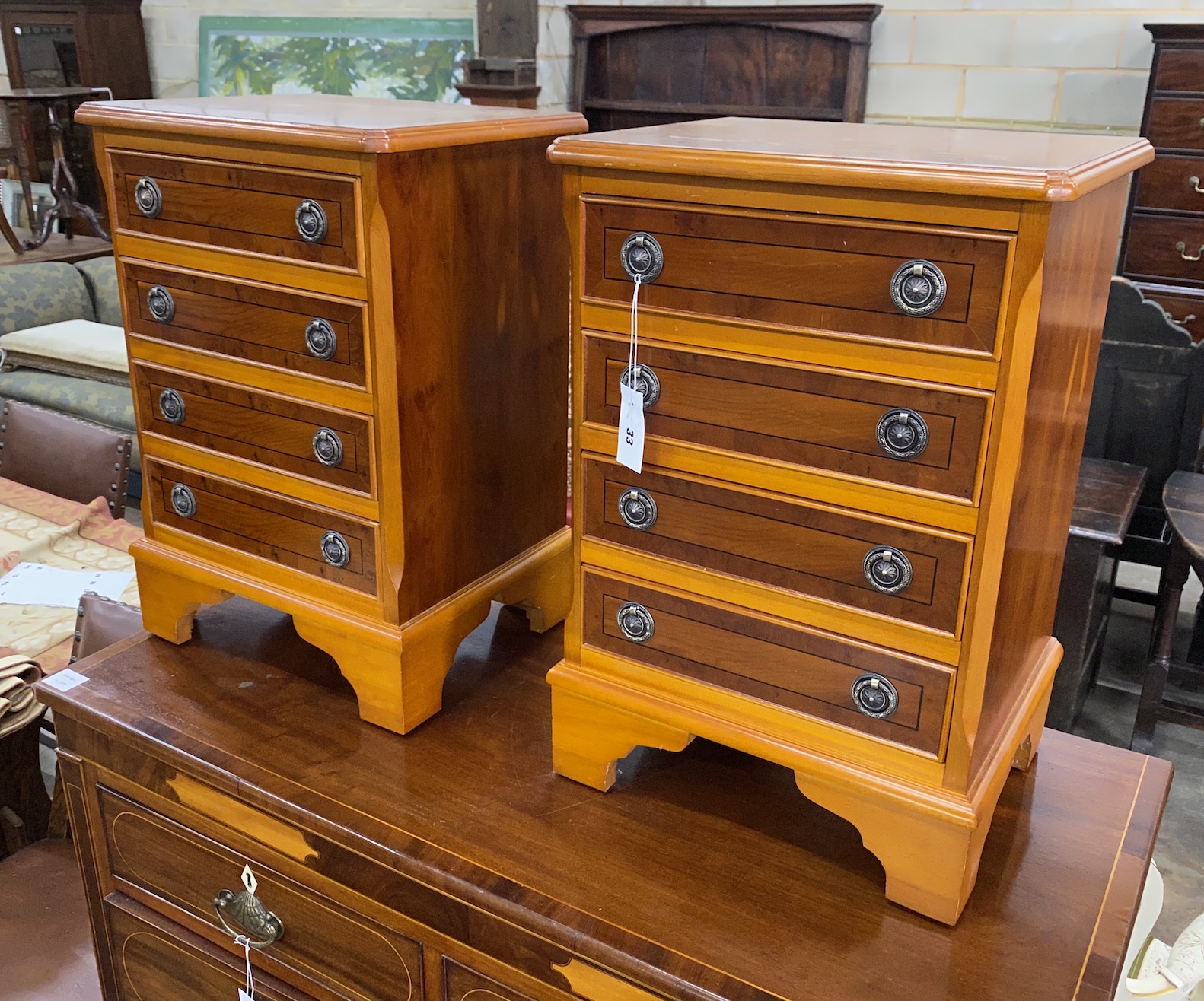 A pair of reproduction yew four drawer bedside chests, width 41cm, depth 32cm, height 60cm